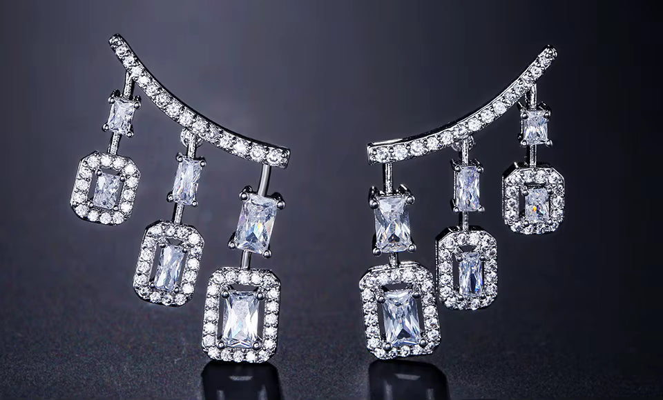 Pair of diamond earrings on a dark background